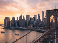 New York City skyline at golden hour from Brooklyn Bridge