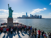 Tourists on ferry approaching Statue of Liberty